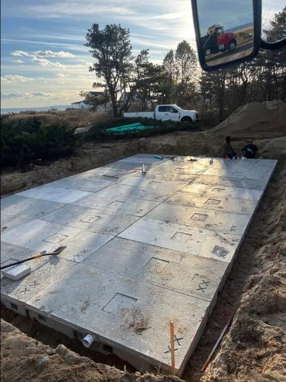 Precast concrete septic tank being set in a Kennebunk yard