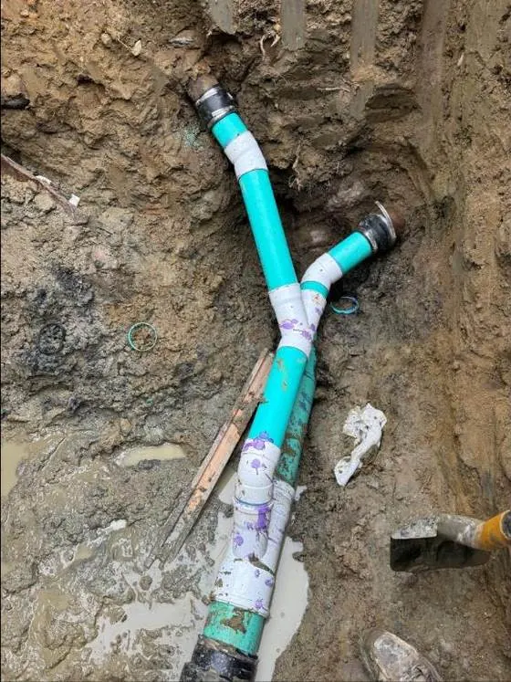 New PVC sewer lateral connected in an open trench